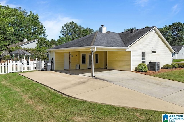 1937 Riva Ridge Rd, Helena, AL 35080 - rear view of house featuring driveway, a carport, central AC, a chimney, and a shingled roof
