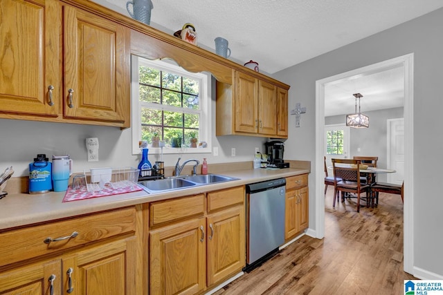 276 River Oak Trl, Hayden, AL 35079 - kitchen with stainless steel dishwasher, a sink, light wood finished floors, and light countertops