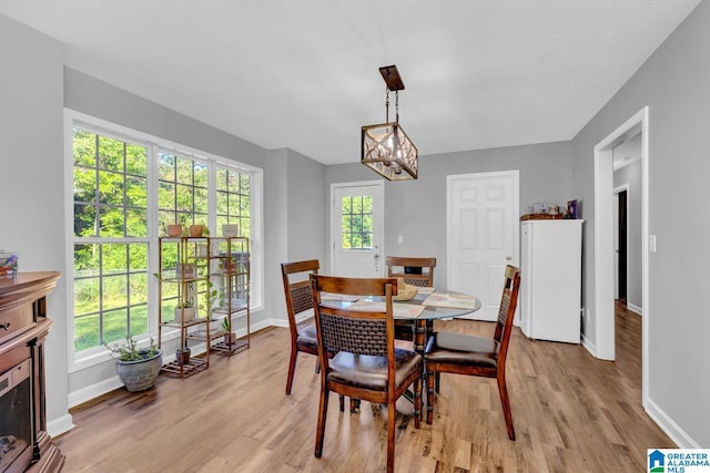 276 River Oak Trl, Hayden, AL 35079 - dining area with light wood finished floors, baseboards, and a chandelier