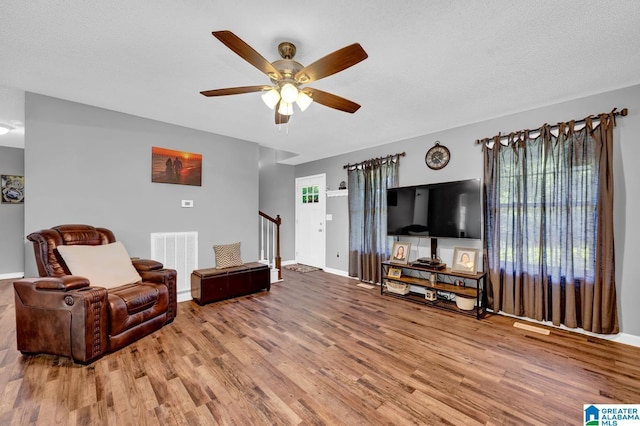 276 River Oak Trl, Hayden, AL 35079 - living area featuring a ceiling fan, wood finished floors, stairs, and baseboards