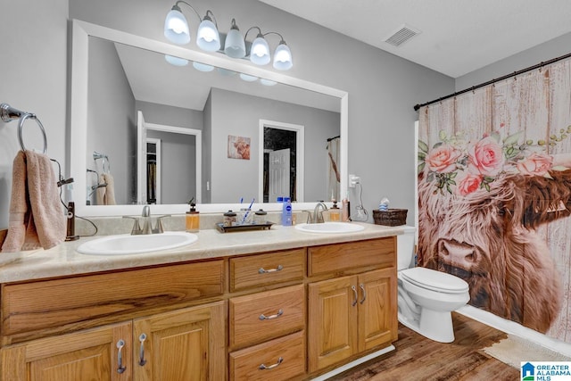 276 River Oak Trl, Hayden, AL 35079 - bathroom featuring double vanity, wood finished floors, toilet, and a shower with shower curtain