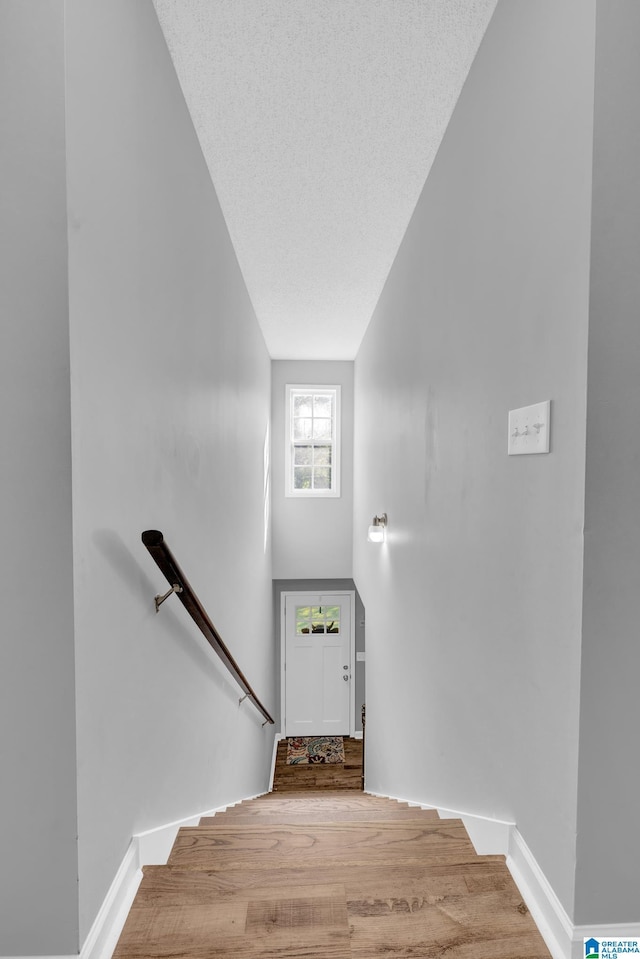 276 River Oak Trl, Hayden, AL 35079 - staircase with wood finished floors, a towering ceiling, and baseboards