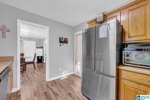 276 River Oak Trl, Hayden, AL 35079 - kitchen with appliances with stainless steel finishes, light wood-style flooring, light countertops, and baseboards