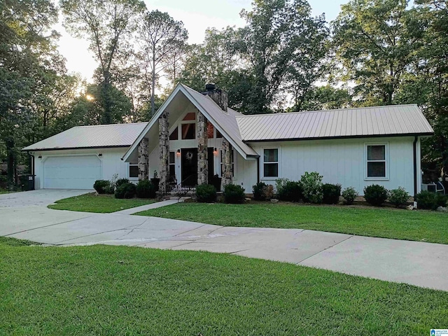 1679 Curry Hwy, Jasper, AL 35503 - view of front of house featuring metal roof, concrete driveway, a garage, a chimney, and a front lawn