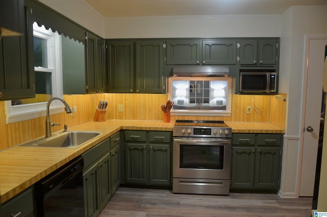 1679 Curry Hwy, Jasper, AL 35503 - kitchen featuring appliances with stainless steel finishes, green cabinets, under cabinet range hood, a sink, and backsplash