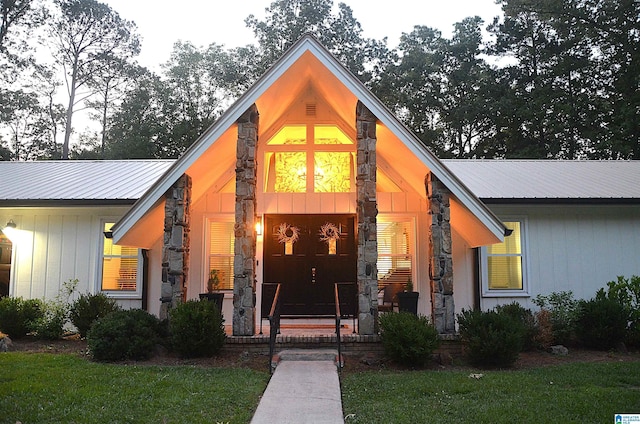1679 Curry Hwy, Jasper, AL 35503 - view of front of home featuring covered porch, stone siding, metal roof, and a front yard