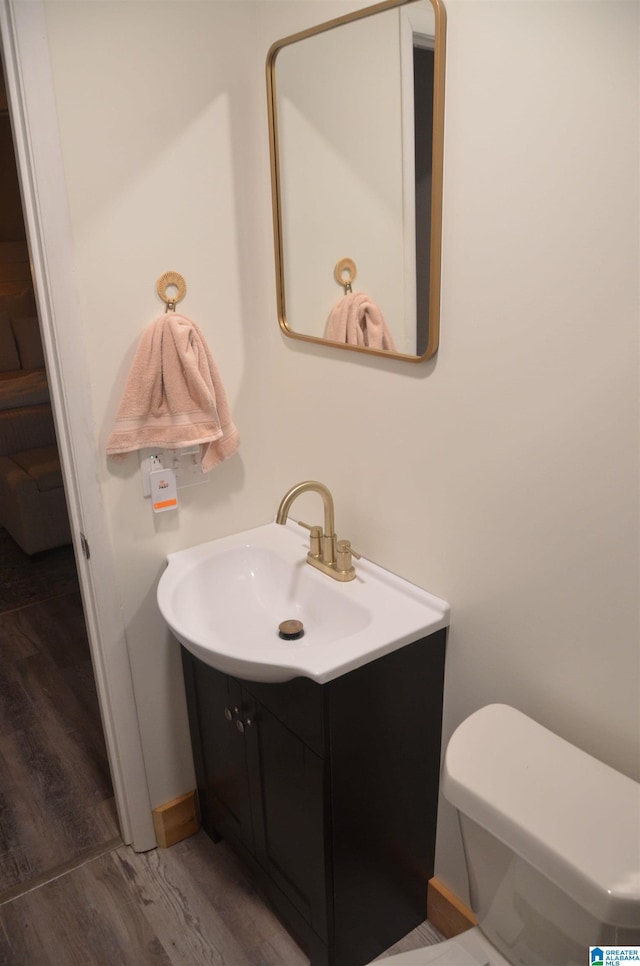 1679 Curry Hwy, Jasper, AL 35503 - half bath with vanity, wood finished floors, toilet, and baseboards