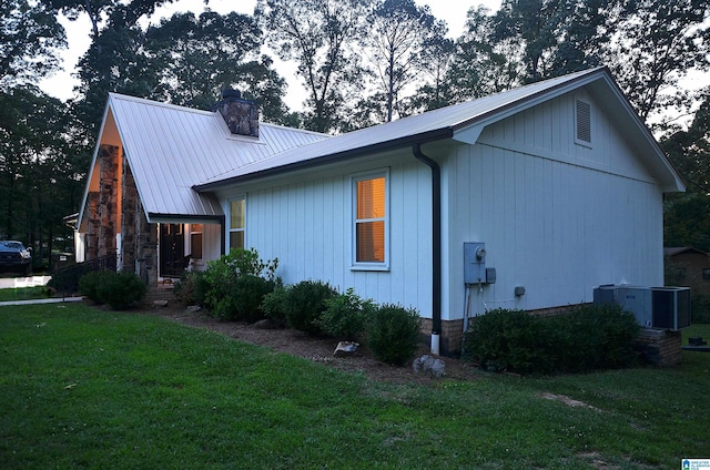 1679 Curry Hwy, Jasper, AL 35503 - view of side of home featuring a lawn, metal roof, a chimney, and cooling unit