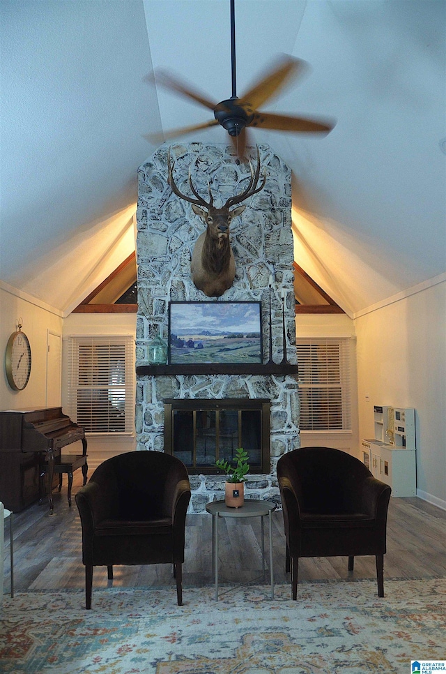 1679 Curry Hwy, Jasper, AL 35503 - living room featuring vaulted ceiling, ceiling fan, crown molding, a stone fireplace, and wood finished floors
