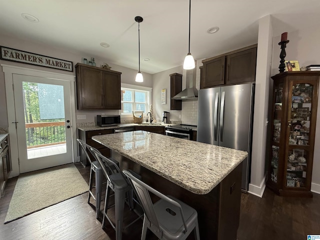 171 Sweetwater Dr, Wedowee, AL 36278 - kitchen featuring stainless steel appliances, wall chimney range hood, dark brown cabinetry, a kitchen island, and recessed lighting