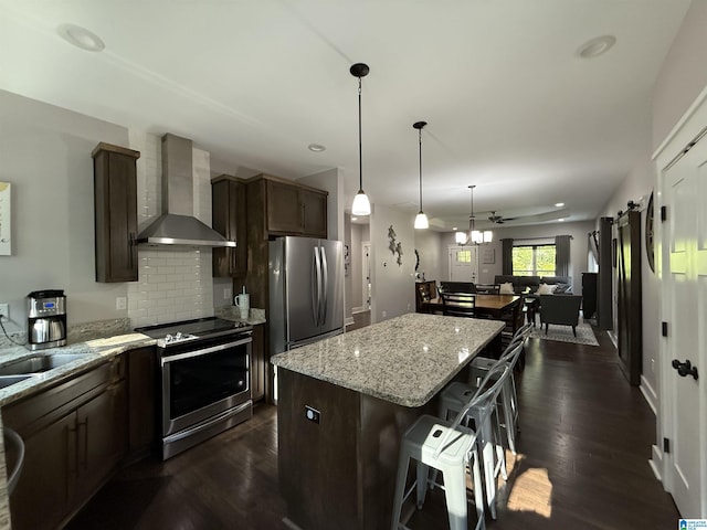 171 Sweetwater Dr, Wedowee, AL 36278 - kitchen with stainless steel appliances, wall chimney exhaust hood, a kitchen island, a breakfast bar, and dark wood-type flooring