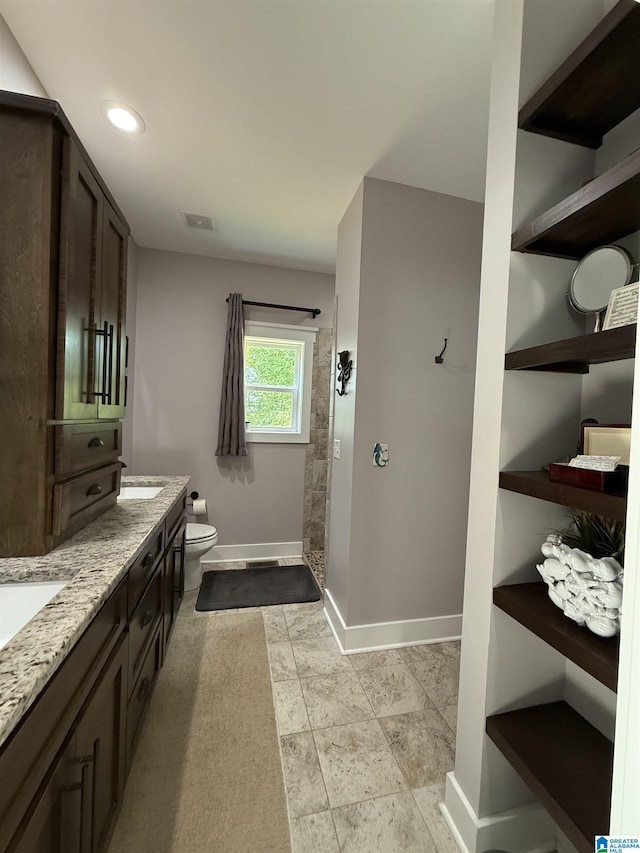 171 Sweetwater Dr, Wedowee, AL 36278 - full bathroom with a tile shower, baseboards, toilet, double vanity, and recessed lighting