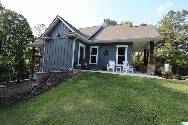 171 Sweetwater Dr, Wedowee, AL 36278 - rear view of house with board and batten siding, a lawn, and a shingled roof