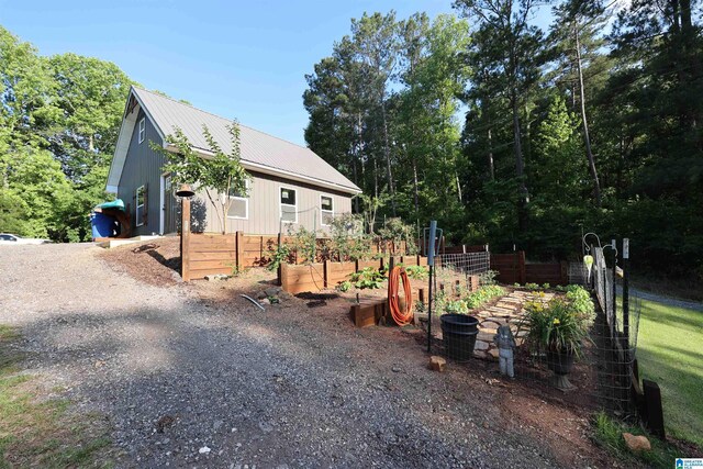 171 Sweetwater Dr, Wedowee, AL 36278 - view of front of home with a vegetable garden and metal roof