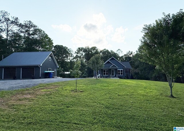 171 Sweetwater Dr, Wedowee, AL 36278 - ranch-style house with an outbuilding, a detached garage, a front yard, metal roof, and a porch