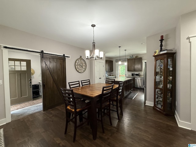 171 Sweetwater Dr, Wedowee, AL 36278 - dining room with a barn door, dark wood-type flooring, baseboards, and a chandelier