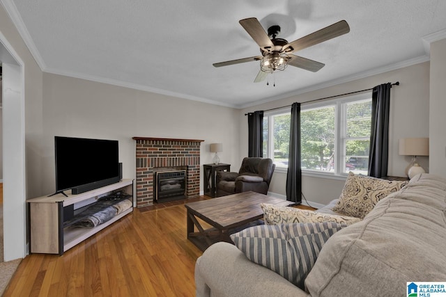 1416 11th St SE, Cullman, AL 35055 - living area with wood finished floors, a ceiling fan, ornamental molding, and a brick fireplace