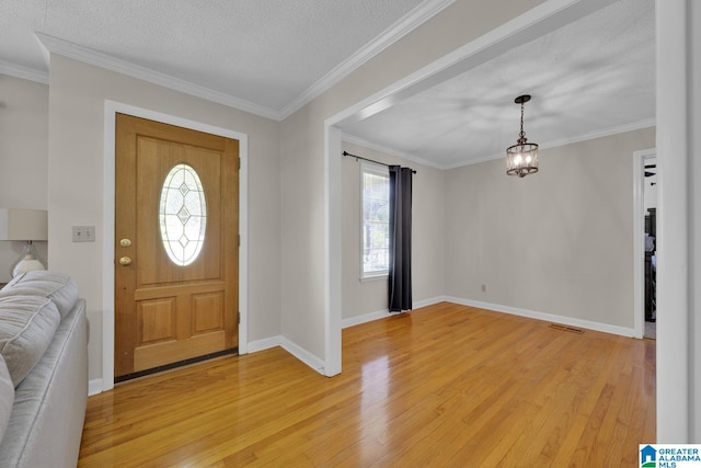 1416 11th St SE, Cullman, AL 35055 - foyer featuring light wood-style flooring, healthy amount of natural light, a textured ceiling, baseboards, and crown molding