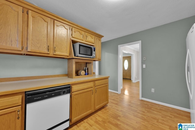 1416 11th St SE, Cullman, AL 35055 - kitchen with white appliances, light countertops, light wood-style floors, and baseboards