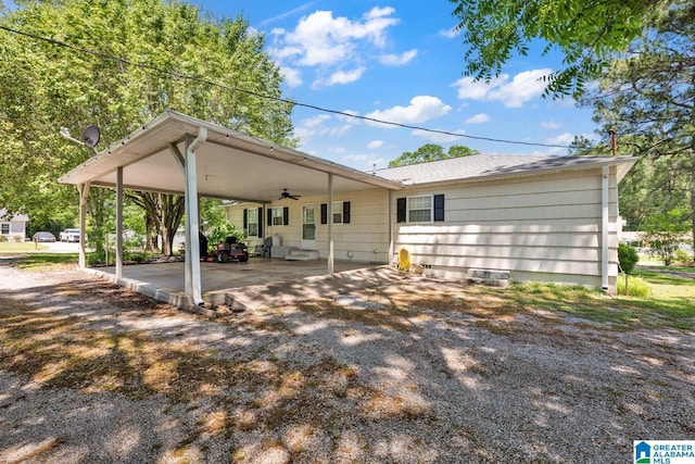 1416 11th St SE, Cullman, AL 35055 - rear view of house with a ceiling fan, a carport, driveway, and a shingled roof