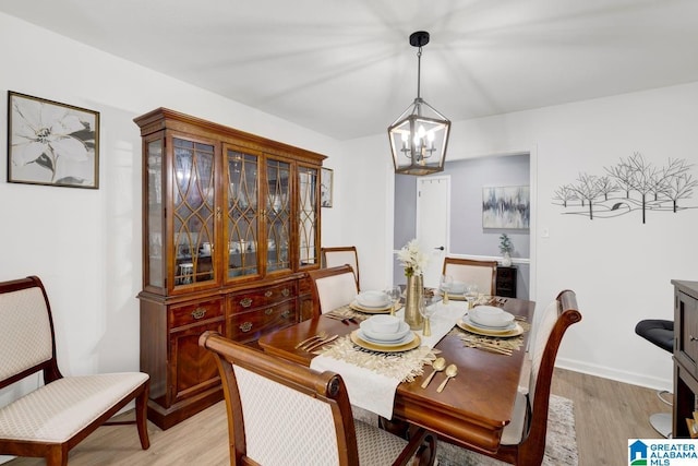 717 Country View Ter, Birmingham, AL 35215 - dining space with a chandelier, light wood-style flooring, and baseboards