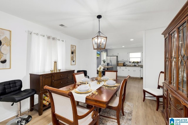 717 Country View Ter, Birmingham, AL 35215 - dining area with a chandelier, light wood-style flooring, and recessed lighting