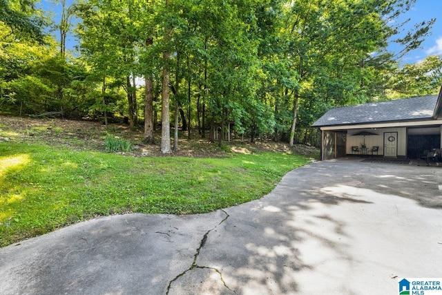717 Country View Ter, Birmingham, AL 35215 - view of green lawn featuring asphalt driveway and a carport