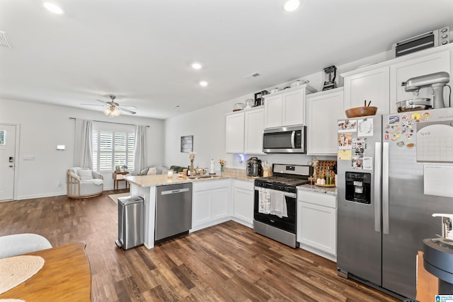 1063 Archers Trl E, Springville, AL 35146 - kitchen featuring appliances with stainless steel finishes, a peninsula, open floor plan, white cabinets, and recessed lighting