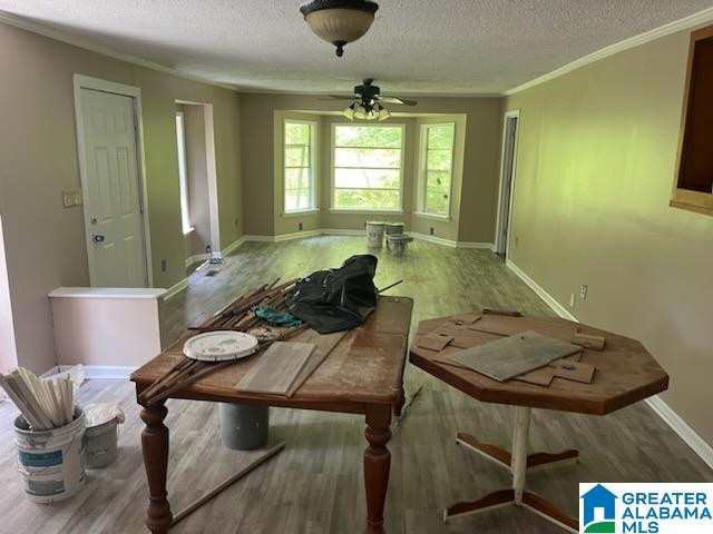 5162 Willow Ridge Ln, Pinson, AL 35126 - dining room featuring a textured ceiling, wood finished floors, ornamental molding, a ceiling fan, and baseboards