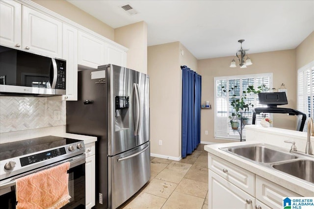 2093 Forest Lakes Ln, Sterrett, AL 35147 - kitchen featuring appliances with stainless steel finishes, a sink, a chandelier, backsplash, and white cabinets