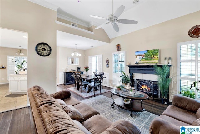 2093 Forest Lakes Ln, Sterrett, AL 35147 - living room featuring a chandelier, plenty of natural light, a tile fireplace, a ceiling fan, and high vaulted ceiling