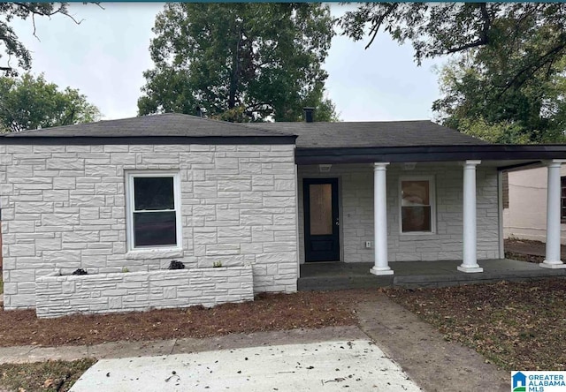 1861 Woodland Ave SW, Birmingham, AL 35211 - view of front facade with covered porch, stone siding, and a shingled roof