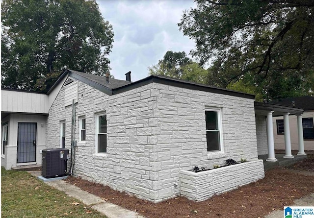 1861 Woodland Ave SW, Birmingham, AL 35211 - view of side of home featuring central AC unit and stone siding