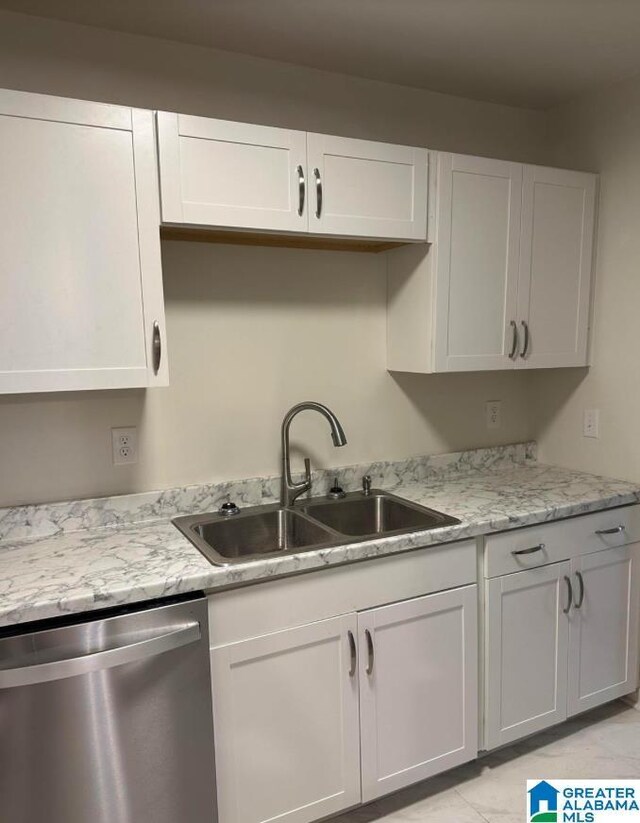 1861 Woodland Ave SW, Birmingham, AL 35211 - kitchen featuring stainless steel dishwasher, a sink, white cabinetry, and light stone countertops