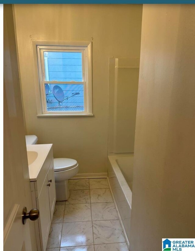 1861 Woodland Ave SW, Birmingham, AL 35211 - bathroom with marble look tiles, toilet, vanity, and baseboards
