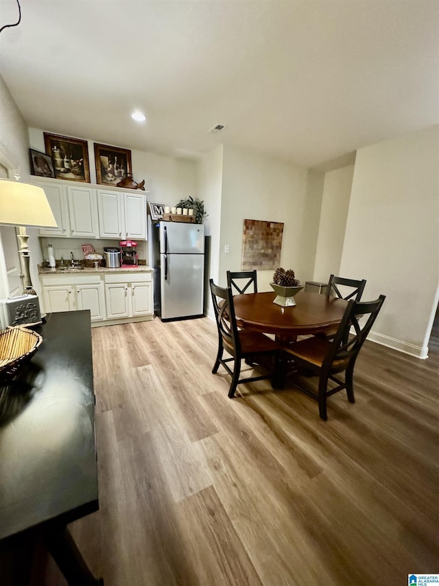 567 Brookwater Way, Wedowee, AL 36278 - dining room with light wood-style flooring, recessed lighting, and baseboards