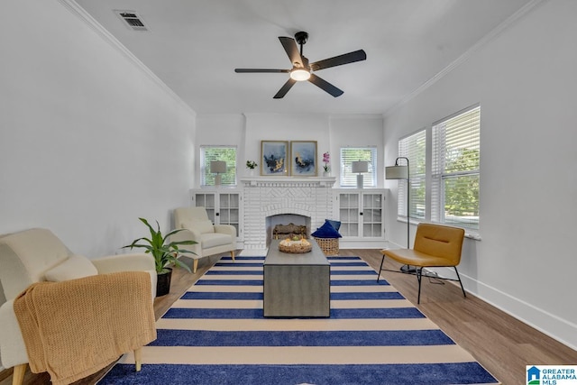 1119 8th Ave W, Birmingham, AL 35204 - living room featuring wood finished floors, ornamental molding, ceiling fan, a fireplace, and baseboards