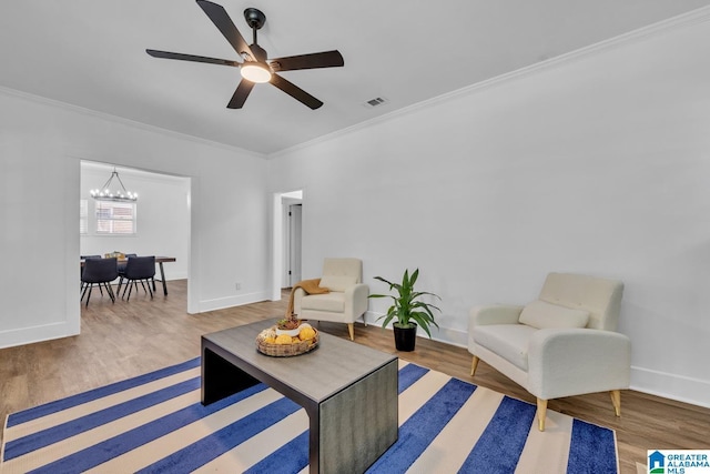 1119 8th Ave W, Birmingham, AL 35204 - living area featuring wood finished floors, crown molding, a chandelier, and baseboards