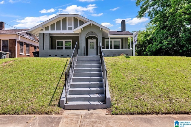 1119 8th Ave W, Birmingham, AL 35204 - view of front facade with brick siding, crawl space, a chimney, and a front yard