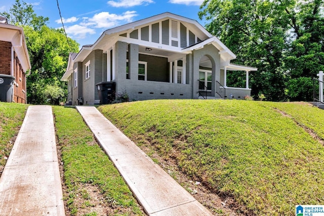 1119 8th Ave W, Birmingham, AL 35204 - view of front of home featuring crawl space, a front lawn, covered porch, and brick siding