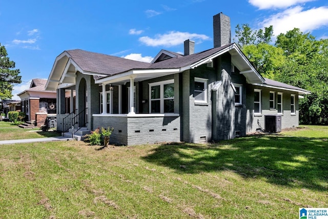1119 8th Ave W, Birmingham, AL 35204 - view of side of home with brick siding, crawl space, central AC, a yard, and a chimney