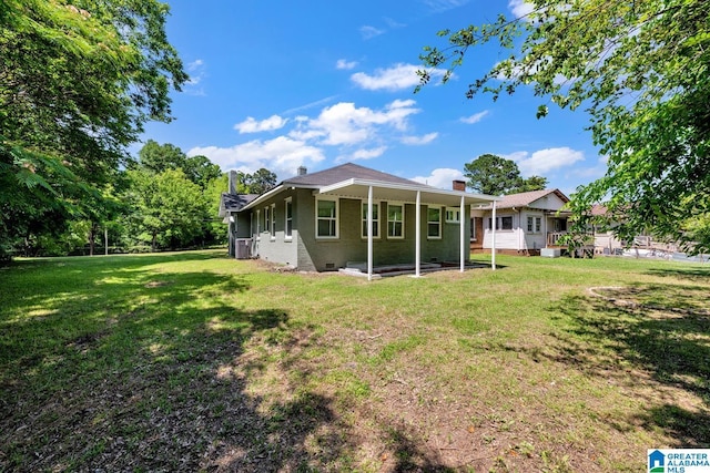 1119 8th Ave W, Birmingham, AL 35204 - rear view of house with a lawn, a chimney, brick siding, crawl space, and cooling unit