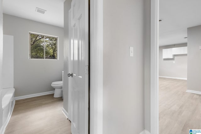 1232 Frisco St, Birmingham, AL 35224 - full bathroom featuring toilet, wood finished floors, baseboards, and a bathtub