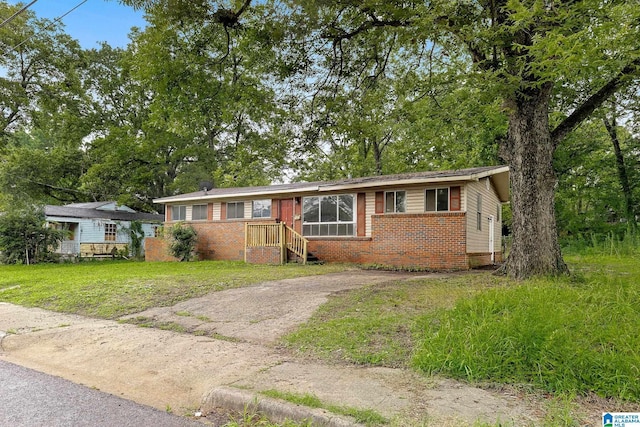 1232 Frisco St, Birmingham, AL 35224 - ranch-style home with brick siding, driveway, and a front yard