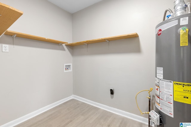 1232 Frisco St, Birmingham, AL 35224 - laundry area featuring water heater, wood finished floors, hookup for a washing machine, baseboards, and electric dryer hookup