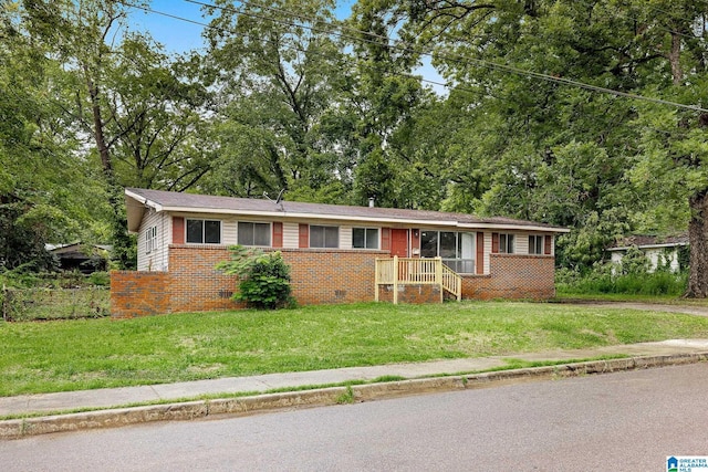 1232 Frisco St, Birmingham, AL 35224 - single story home featuring brick siding, a front yard, and view of scattered trees