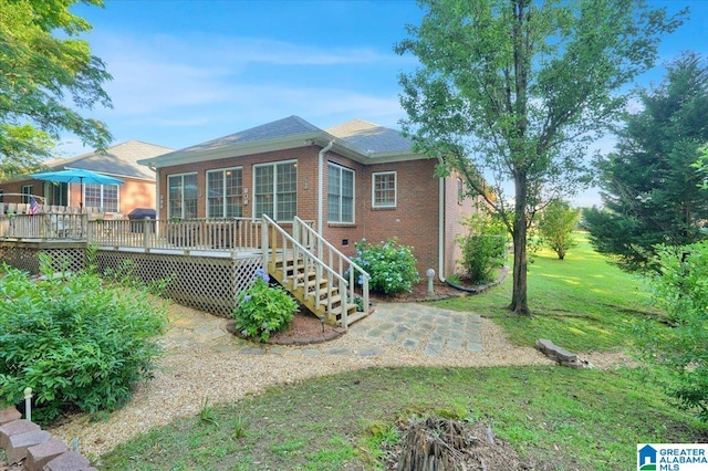 617 Golden Eagle Cir, Jasper, AL 35504 - rear view of property with brick siding, a wooden deck, a patio area, and a yard