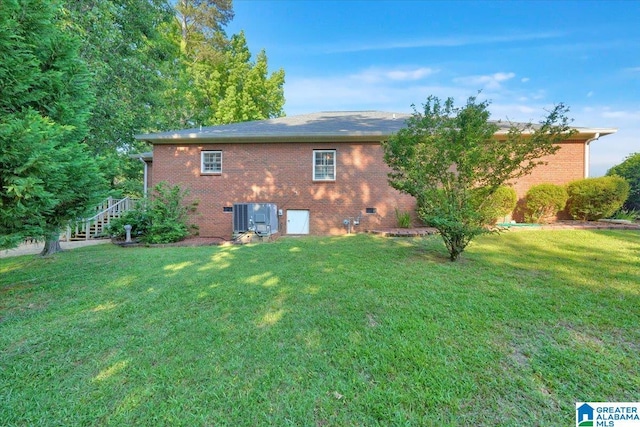 617 Golden Eagle Cir, Jasper, AL 35504 - rear view of house featuring a lawn, brick siding, and central AC unit