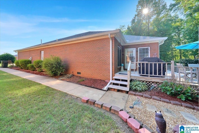 617 Golden Eagle Cir, Jasper, AL 35504 - view of property exterior with brick siding, a deck, a yard, and crawl space
