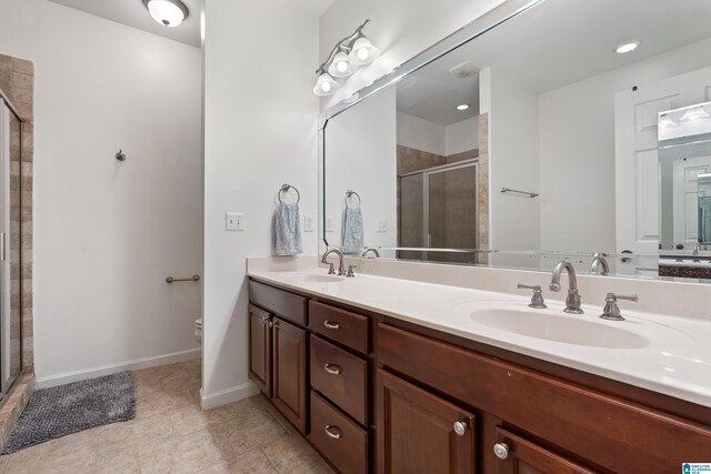 5846 Water Branch Rd, Hoover, AL 35244 - full bathroom featuring a shower stall, double vanity, toilet, baseboards, and tile patterned floors